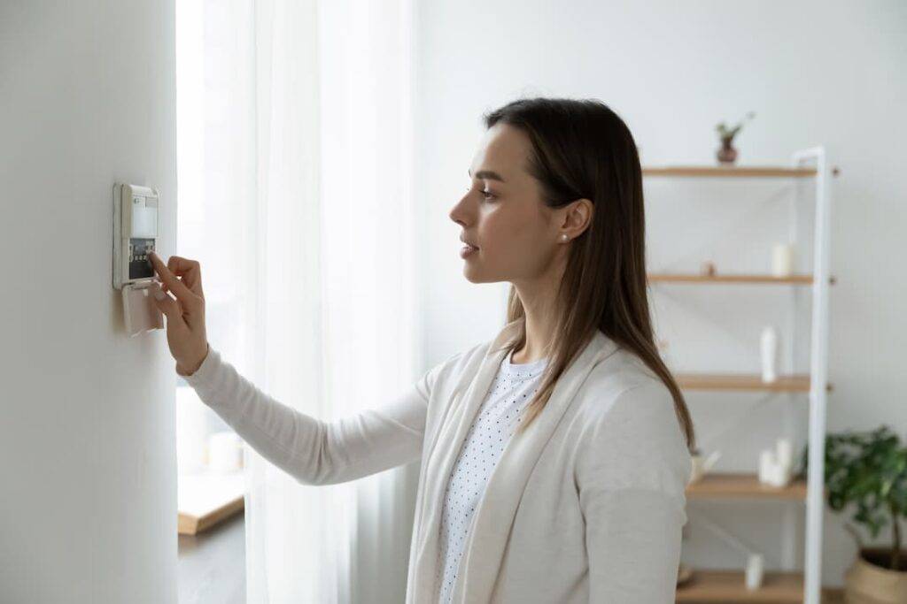 Woman adjusting themostat